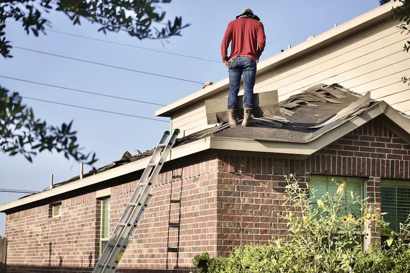 Professional roofer working on a residential roof in Rollingwood Estates